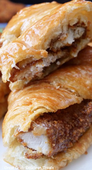 A close up of two fried chicken croissant sandwiches with honey butter.
