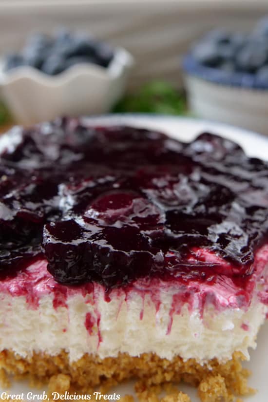 A close up of a serving of cream cheese blueberry dessert.