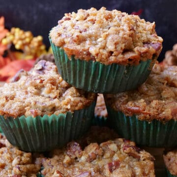 Six butternut squash muffins stacked on top of each other.