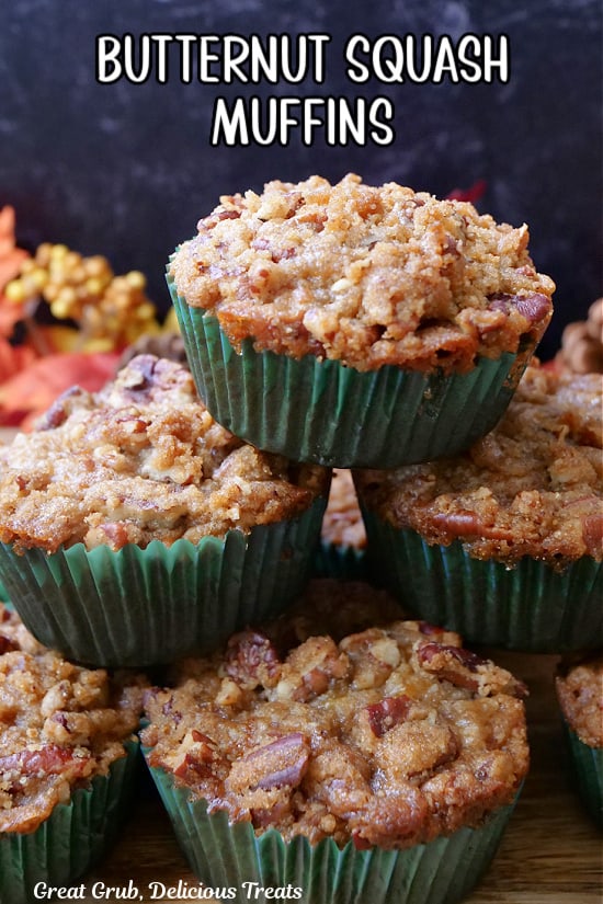 Six butternut squash muffins stacked on top of each other.