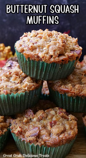 A stack of muffins on a wood surface.