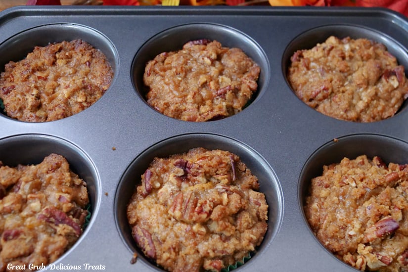 A muffin tin with butternut muffins in it after being baked.