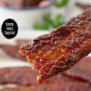 A close up of a piece of candy bacon.