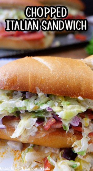 Half of hoagie roll filled with chopped Italian cold cuts, and a lettuce mixture.