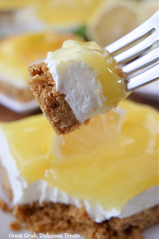 A bite of lemon cream cheese dessert on a fork.