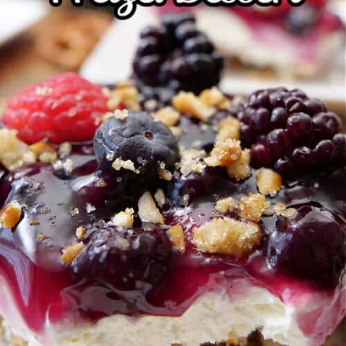A close up of a slice of mixed berry pretzel dessert on a white plate.