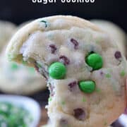 A close up photo of a sugar cookie with a bite taken out of it.