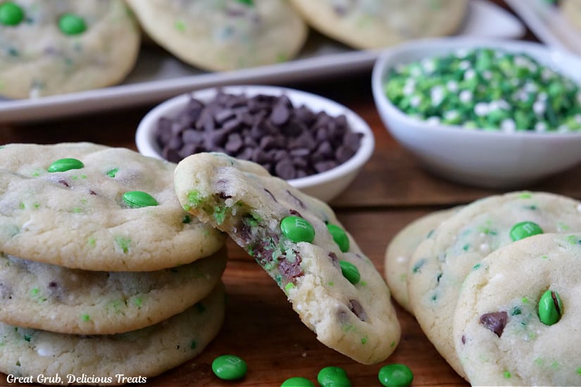 A horizontal photo of St Patrick's Day Sugar Cookies with a bite taken out of one of them.