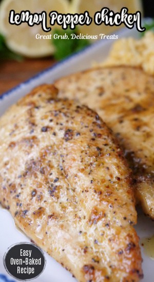 Two lemon pepper chicken breasts on a white plate with blue trim with two lemons in the background.
