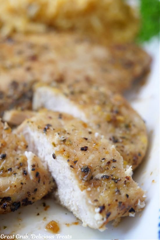 A chicken breast that has been cut into bite size pieces on a white plate