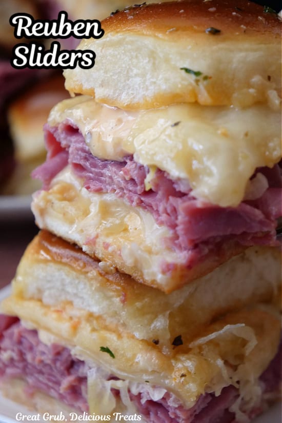 A close up photo of two Reuben sliders with the title of the recipe at the top left corner.