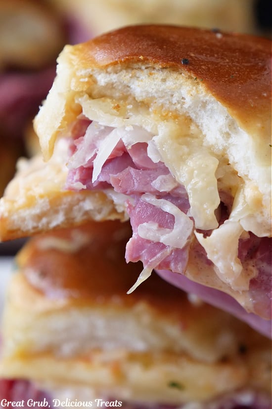 A close up of a Reuben Slider with a bite taken out of it.