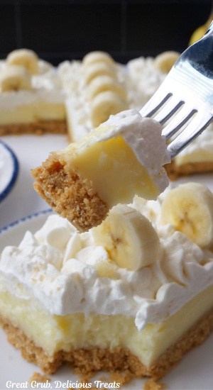 A bite of banana cream dessert on a fork.