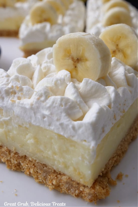 A close up of a serving of a banana bar on a white plate.