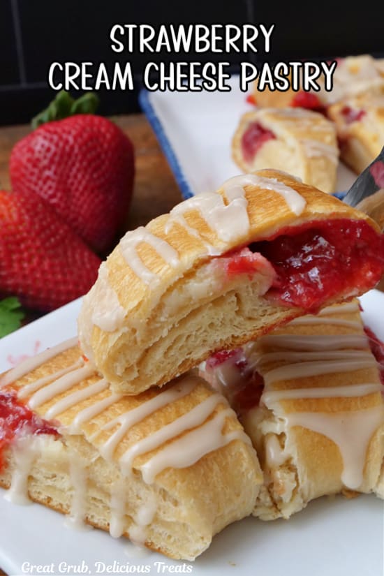 A white plate with three slices of strawberry pastries on it.