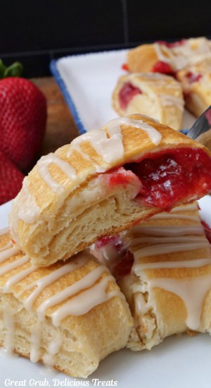 A few slices of strawberry pastry on a white plate.