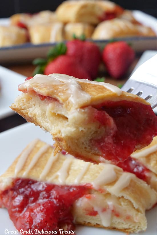 A bite of strawberry cream cheese pastry on a fork.