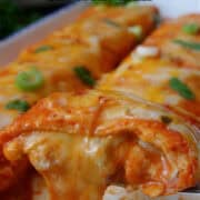 Two cheese enchiladas on a white plate with the title of the recipe at the top of the photo.