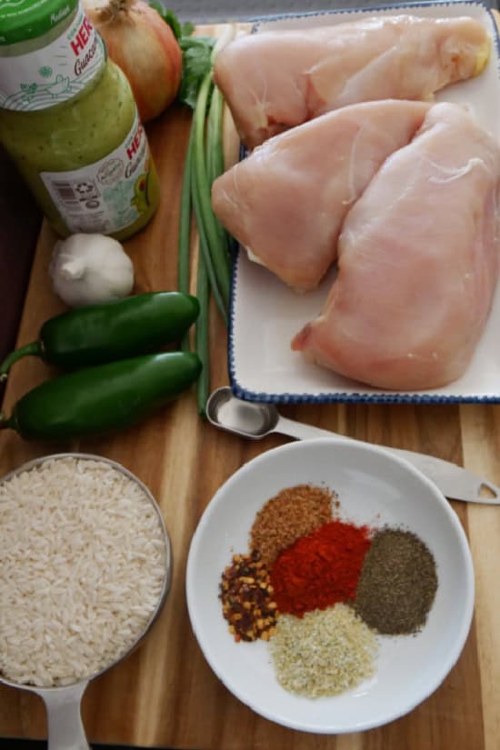 A wood cutting board with all the ingredients laid out on it.