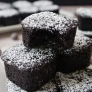 Brownie bites with powdered sugar on top of them.
