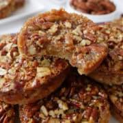 A small stack of mini pecan pies on a white plate.