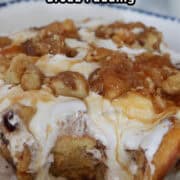 A serving of rocky road bread pudding on a white plate with blue trim.