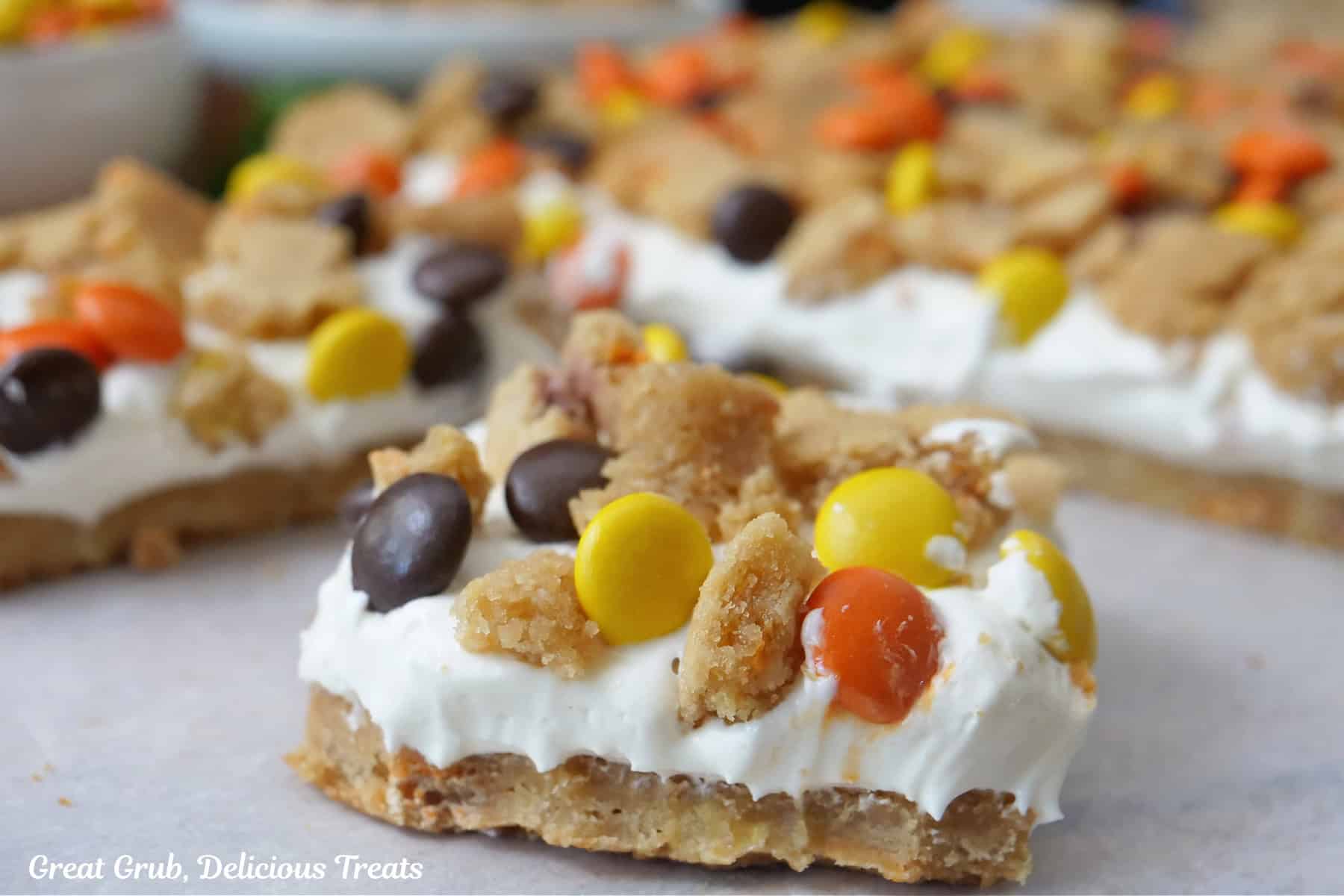 A white surface with servings of peanut butter cookie dessert.