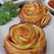 Two caramel apple roses on a white plate with the title overlay at the top.