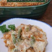 A white bowl with blue trim filled with a serving of cheesy chicken green bean casserole with a title overlay at the top.