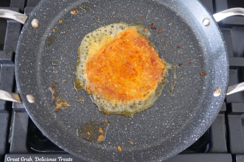 A pan with a cheesy crunch "tortilla" being fried.