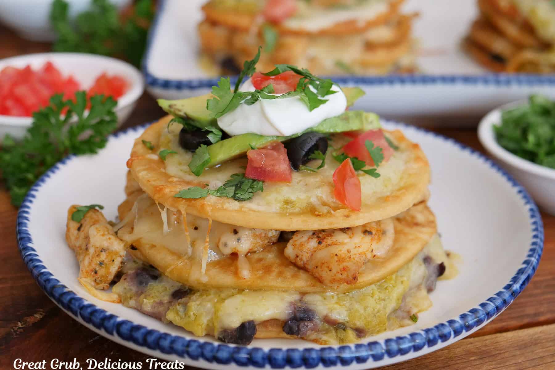 A three layered mini Taco Bell copycat Mexican pizza made with chicken, green sauce, black beans on cheese.