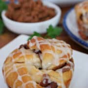 A small white plate with a maple bacon muffin on it and the title overlay at the top.