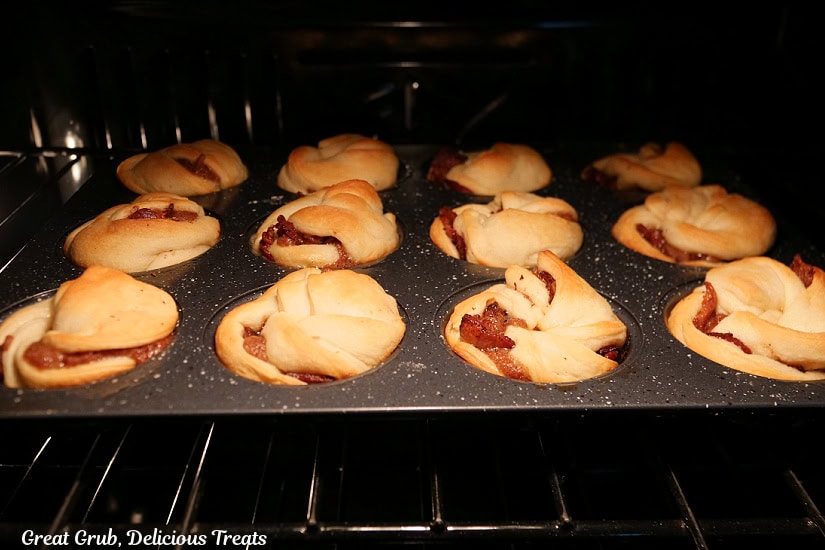 Twelve maple bacon muffins being baked in the oven.