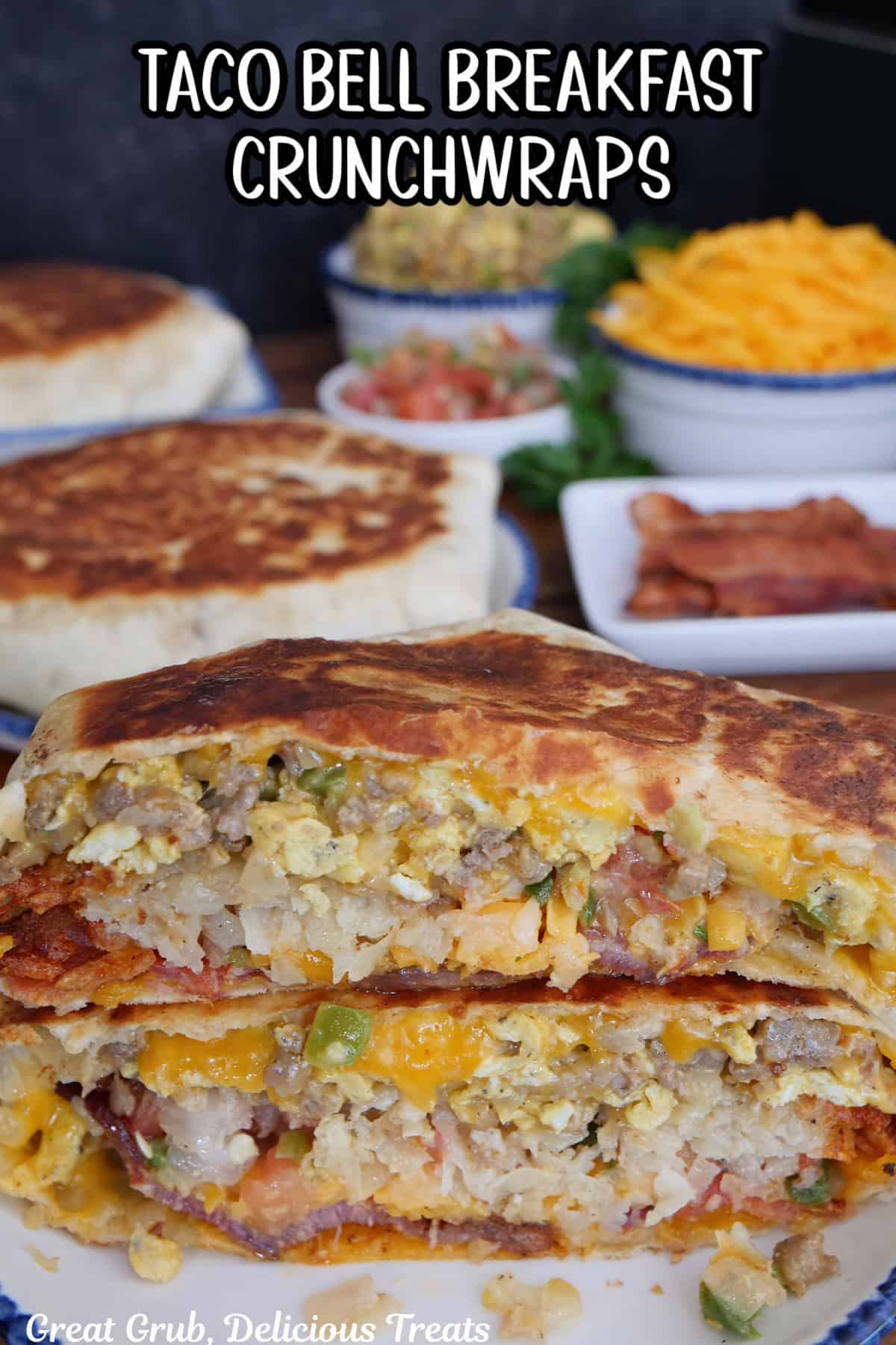 A white plate with a taco bell breakfast crunch wrap cut in half and stacked on top of each other showing all the inside ingredients.