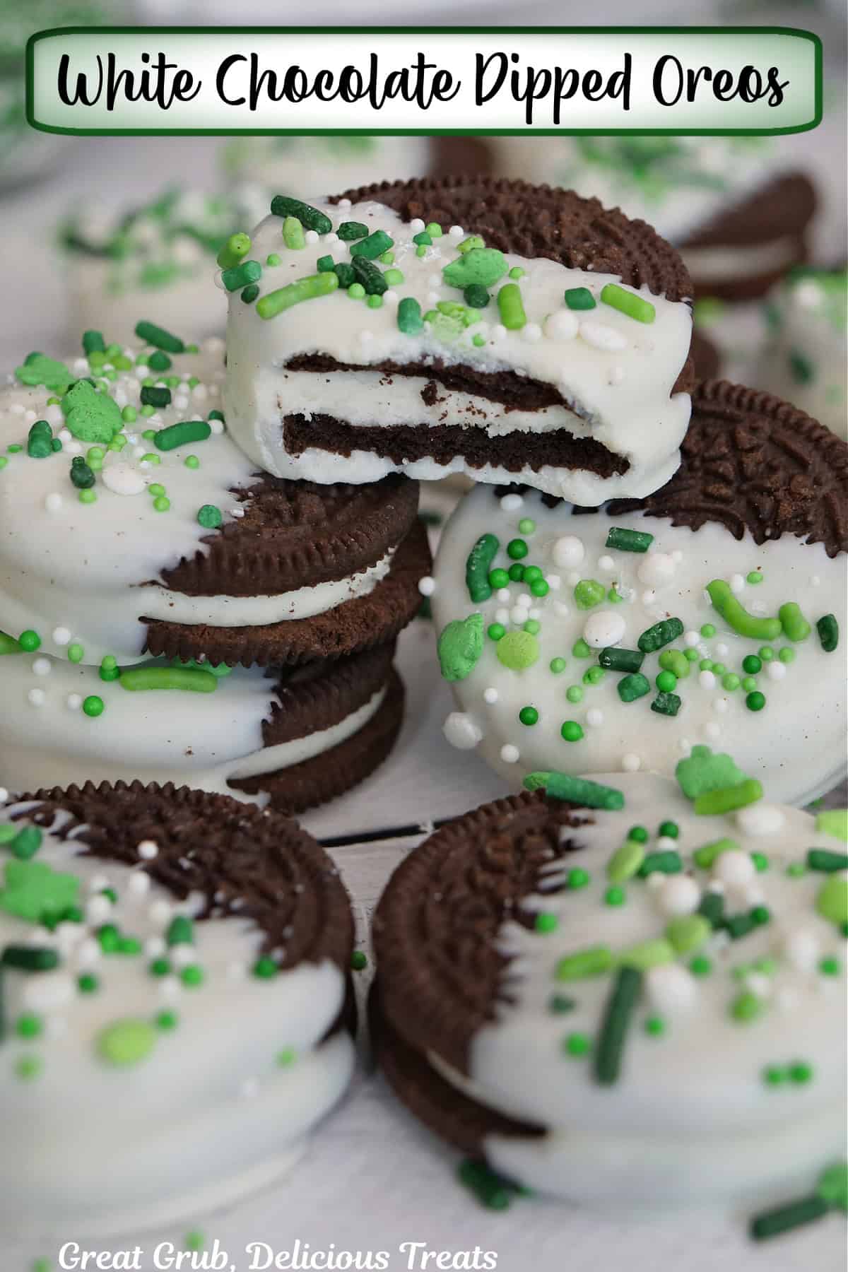 A white surface with white chocolate dipped Oreos with St. Patrick's Day sprinkles on them.