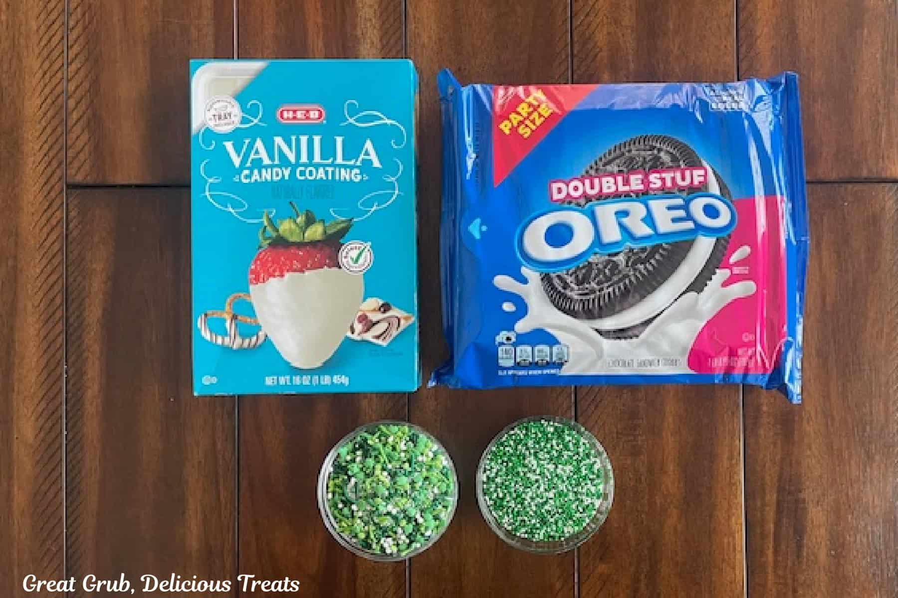 A wood surface with the ingredients to make white chocolate dipped Oreos on it.
