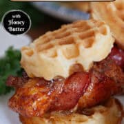 A white round plate with blue trim with a bacon wrapped chicken and waffle slider with honey butter on it, and a title overlay at the top.
