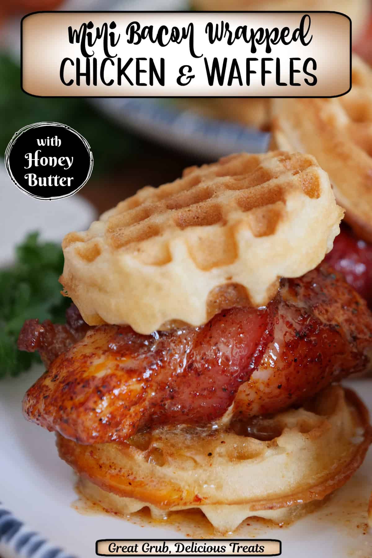 A white round plate with blue trim with a bacon wrapped chicken and waffle slider with honey butter on it, and a title overlay at the top.