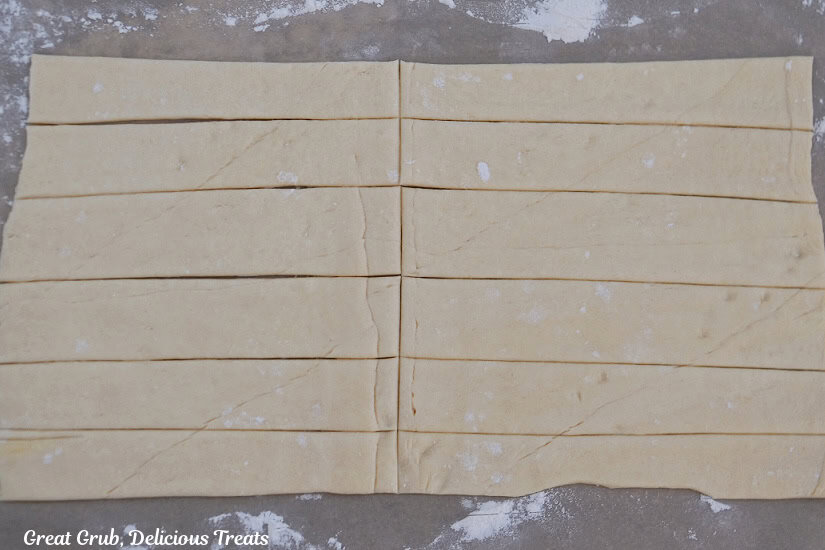 Crescent dough cut into six long strips and then cut in half making 12 strips.