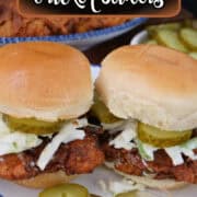 A round white plate with blue trim with two Nashville hot chicken sliders on it with a title overlay at the top.