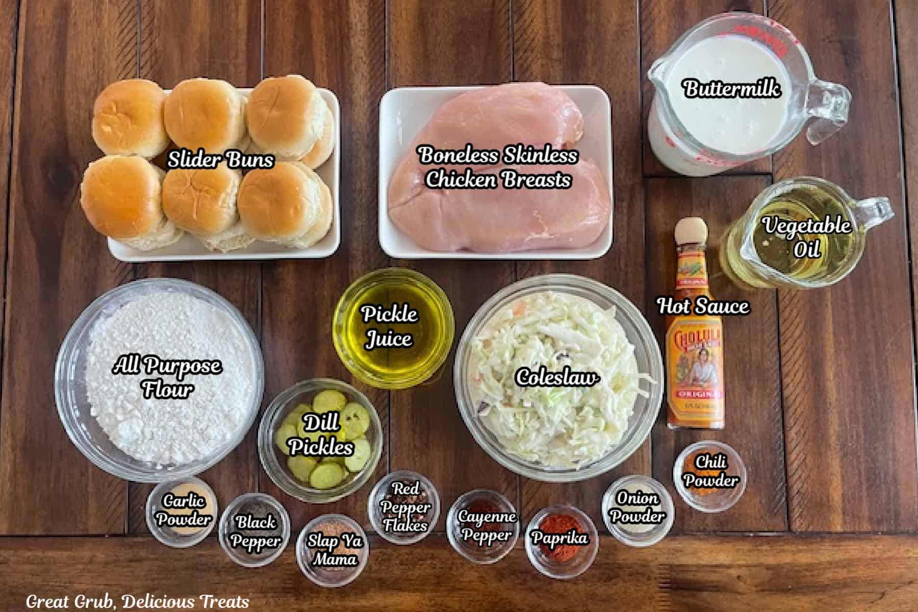 A wood surface with all the ingredients placed on it to make Nashville hot chicken sliders.