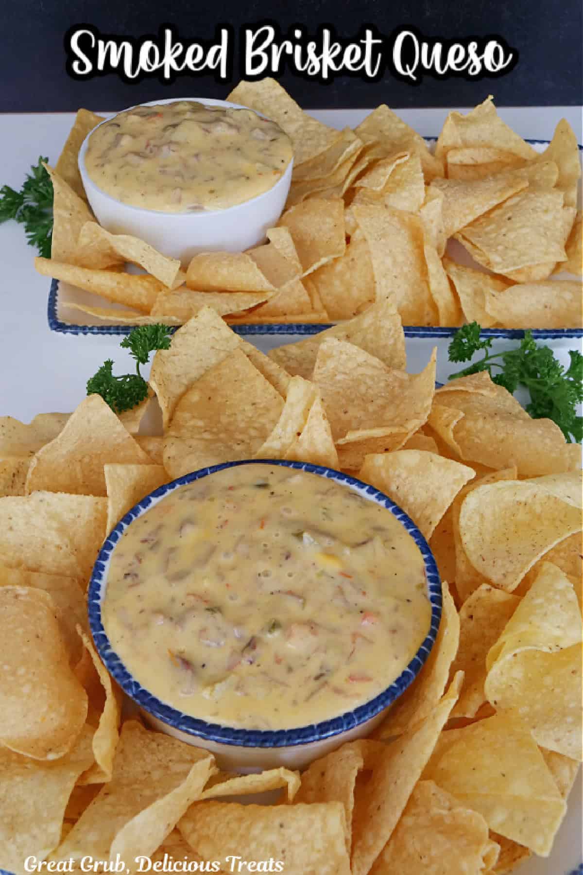 A white surface with tortilla chips placed around two bowls filled with smoked brisket queso, and a title overlay at the top.
