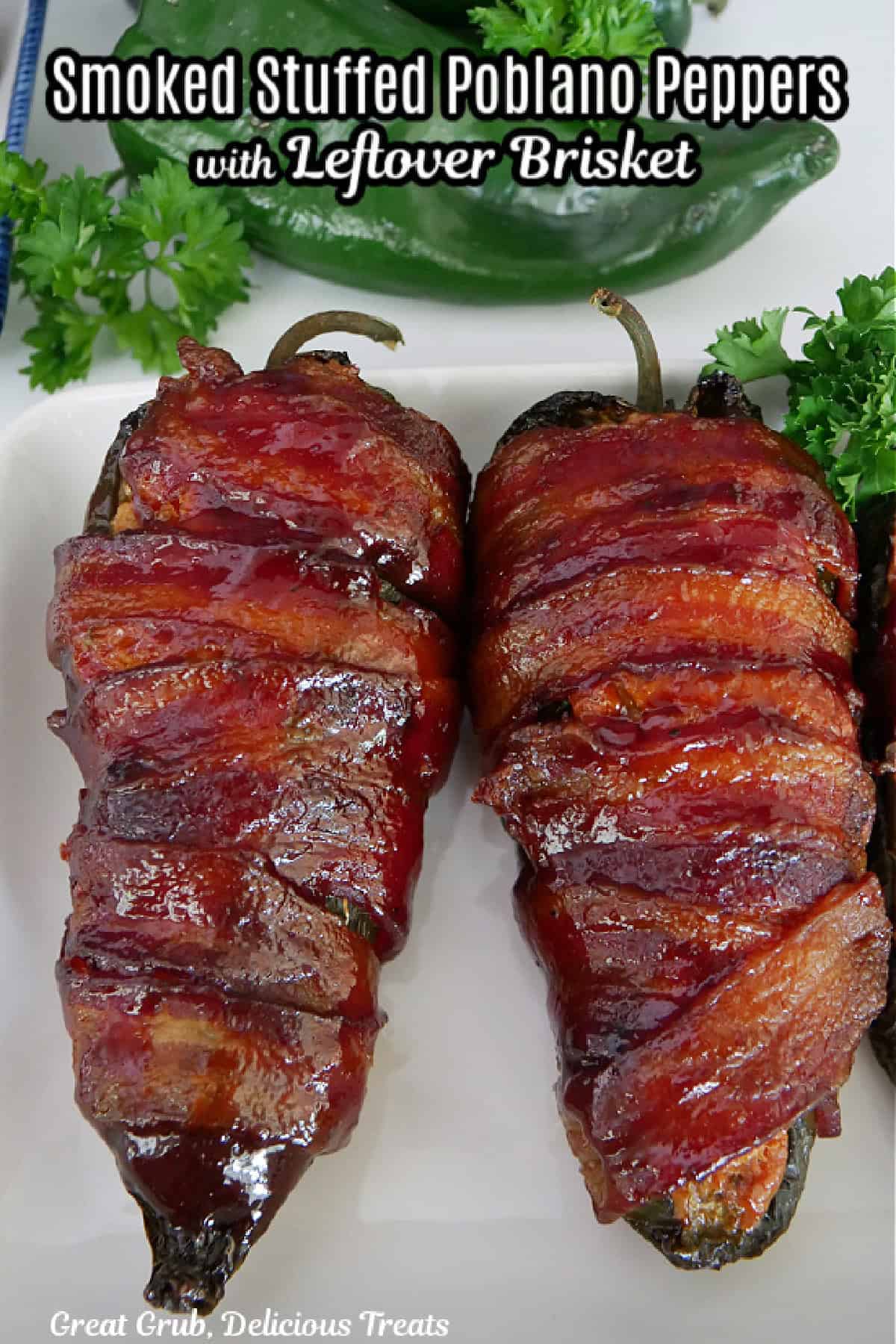 A white surface with two smoked stuffed poblano poppers on it, with a title overlay at the top.