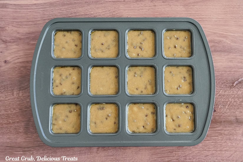 A 12-count brownie tin with the blondie batter in it before being baked.