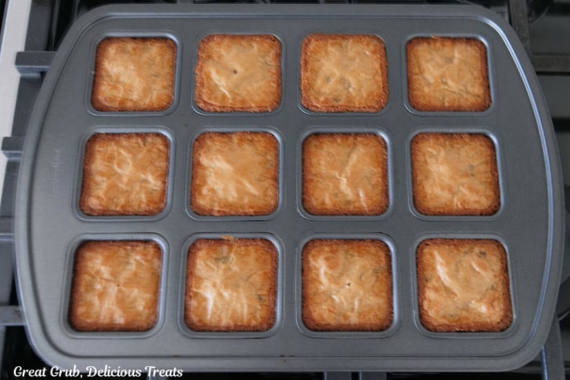 A 12-cound brownie tin with the baked blondies in it after being baked.