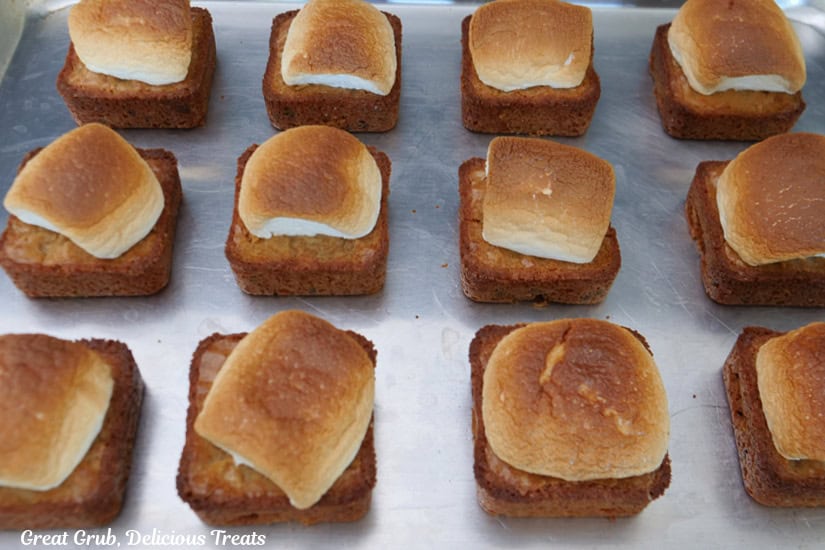 A baking sheet with the toasted marshmallow topped blondies after being removed from the oven.