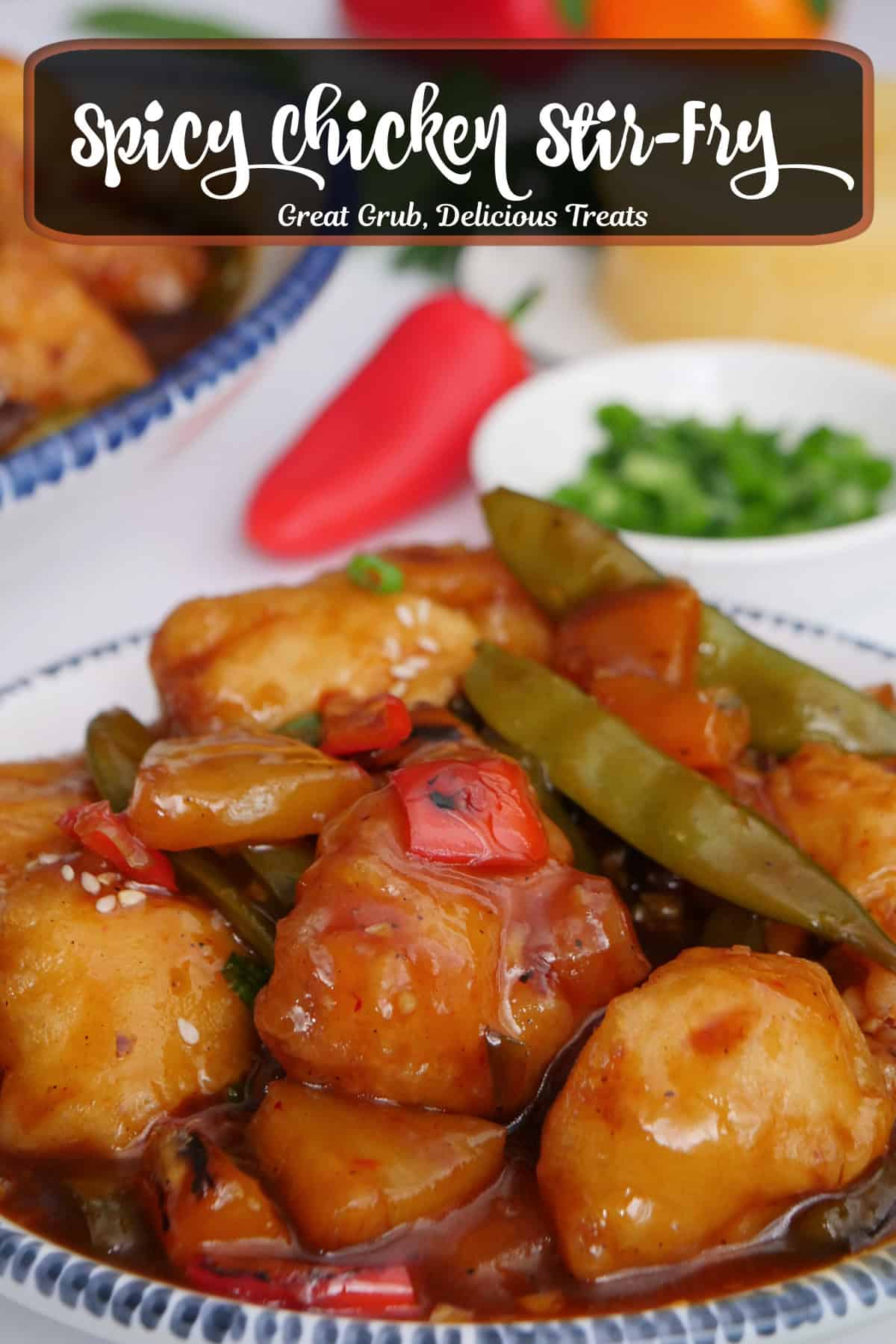 A round white plate with blue trim filled with a serving of spicy chicken stir-fry with a title overlay at the top.