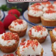 A white surface with bite-size mini strawberry cheesecake bites on it with a title overlay at the top.