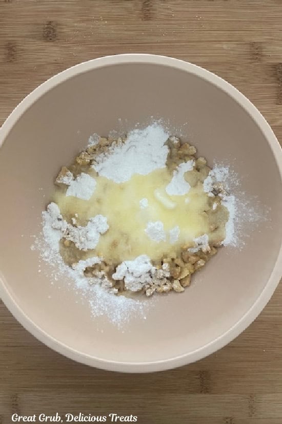 A cream colored bowl with the lemon crunch ingredients in it before it is mixed together.