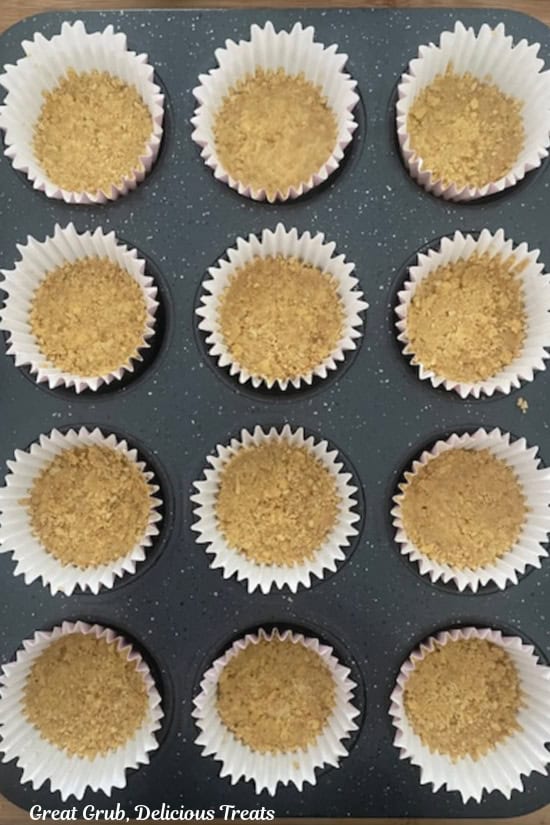 A 12-count muffin tin with lemon cookie crust pressed into each cupcake liner.